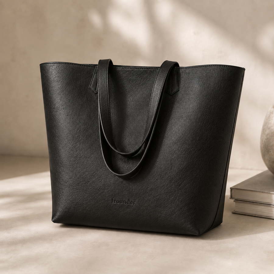 Black Daygrove tote standing upright with its handles folded forward.