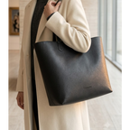 Black Daygrove tote carried over one shoulder.