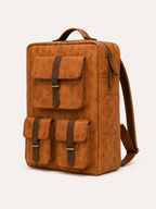 Trailhead Daypack angled front view showing three flap pockets, a top handle and side pocket.