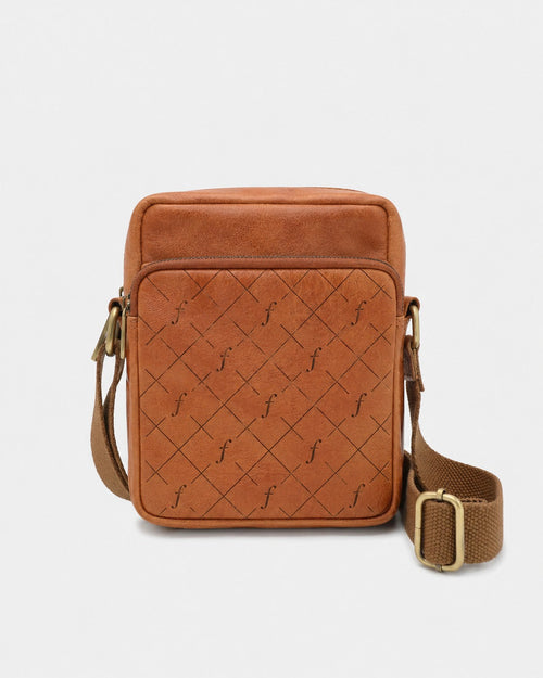 Bracken Mini Crossbody front view with patterned zip pocket and adjustable woven strap.