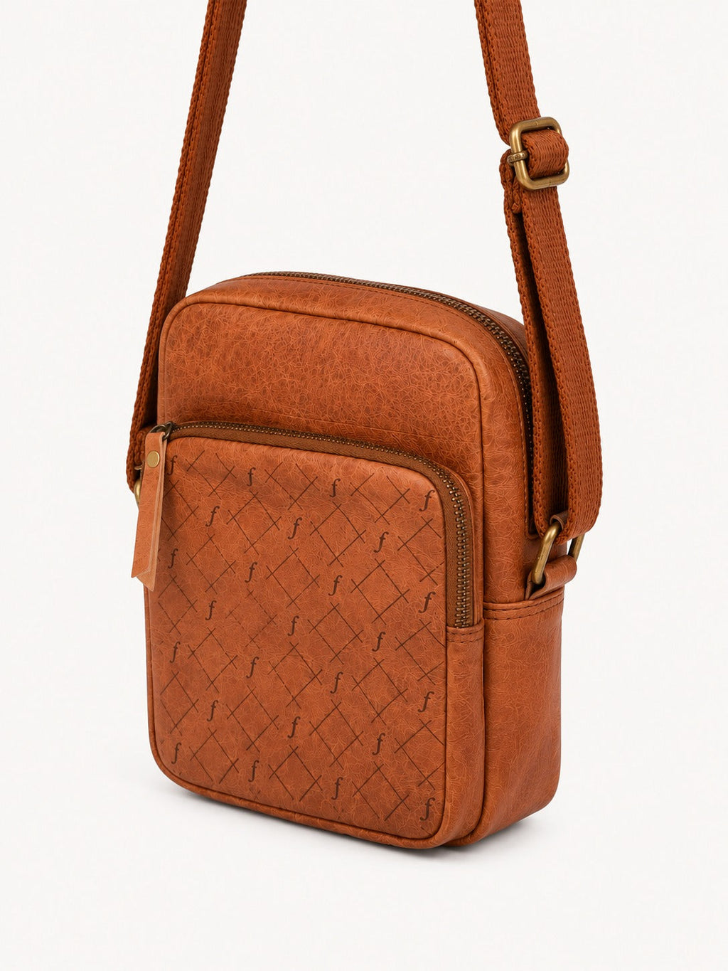 Bracken Mini Crossbody angled view showing the front zip pocket, main zip and strap attachment.