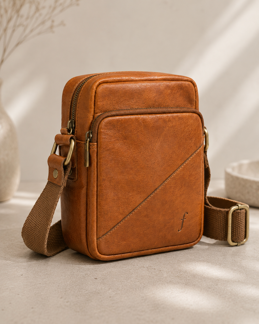 Angled view of Sprig showing separate main and front pocket zippers and side strap attachment.