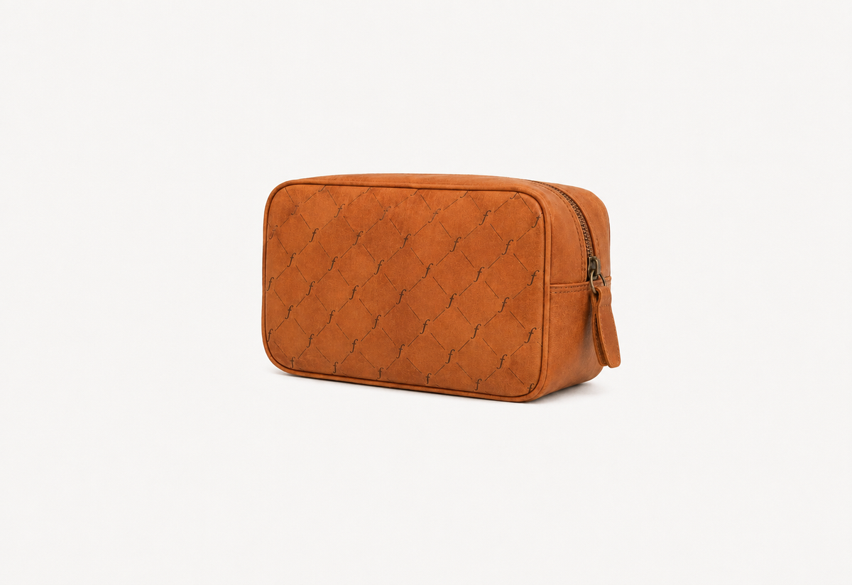Washwood Toiletry Bag pouch in tan, showing the patterned front panel, rounded corners and zipped closure.