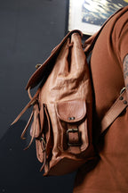 Close side view of Crest while worn, showing the drawstring edge and buckled side pocket.