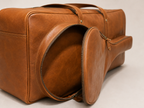 Close view of the Courtside bag with its racket-shaped front compartment unzipped.