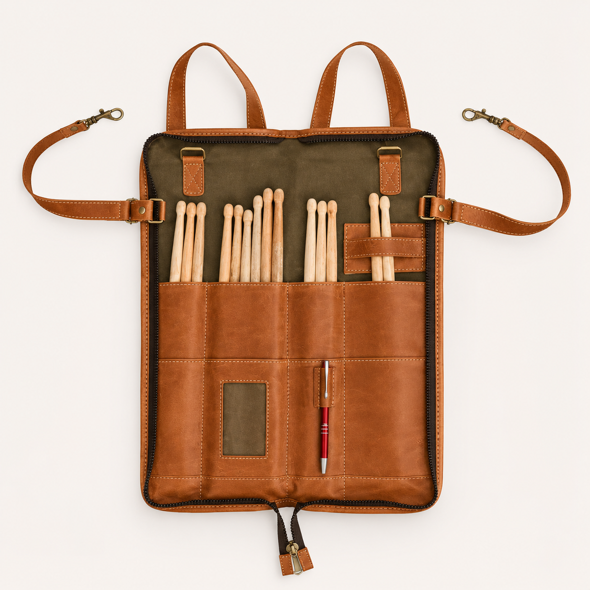 Backbeat Drumstick Bag unzipped and opened flat, with drumsticks in divided pockets, a pen loop, card window and clip-ended straps.