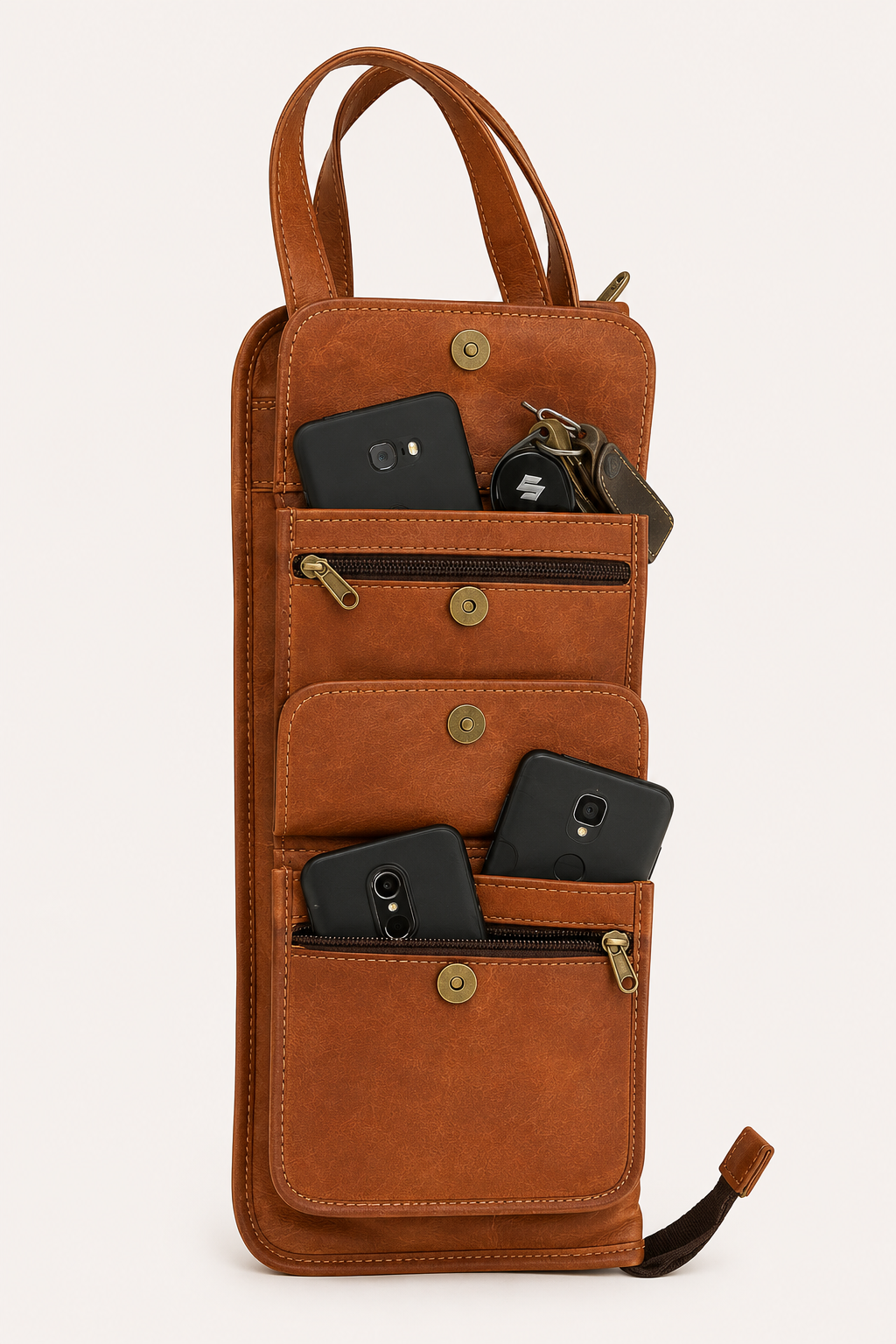 Backbeat Drumstick Bag with exterior pocket flaps open, showing zipped pockets and phones and keys used to illustrate storage.