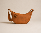 Fernway Sling front view showing its curved body and adjustable woven shoulder strap.