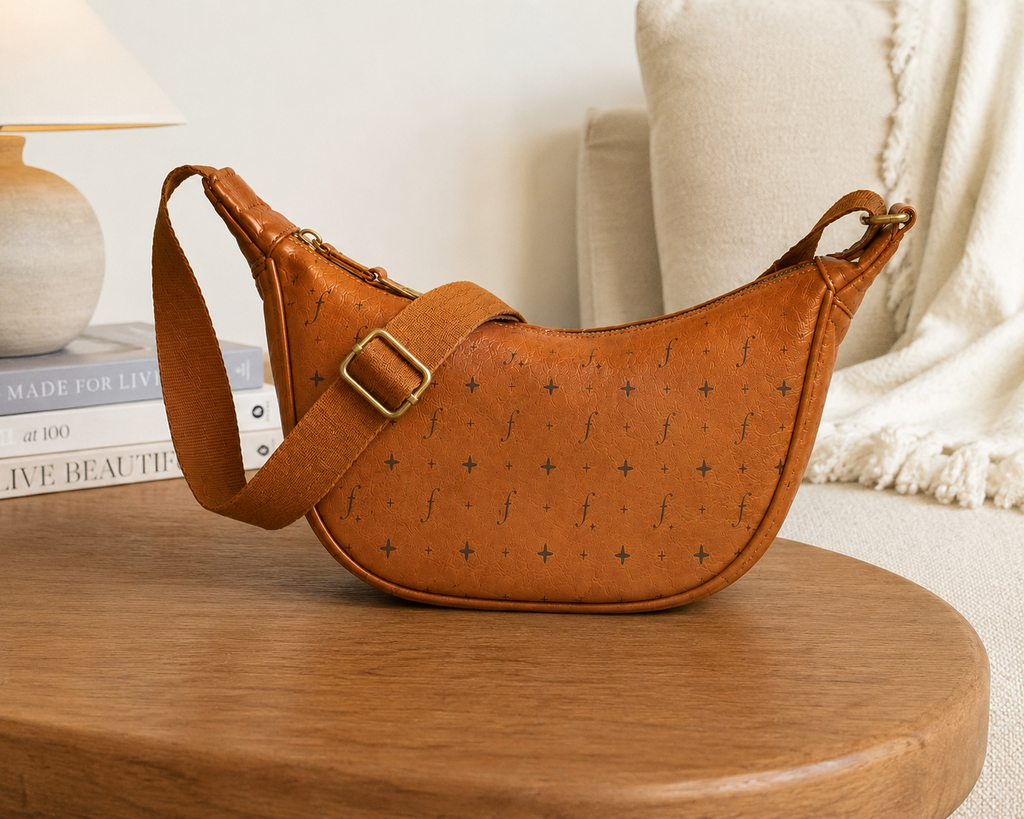 Fernway Sling standing on a wooden table with its strap draped across the front.
