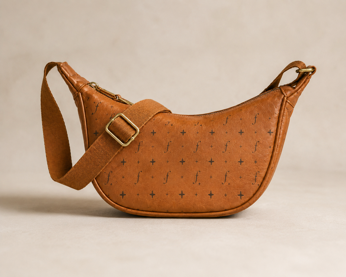Fernway Sling front detail showing the patterned surface, edge piping and strap adjuster.