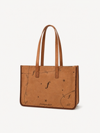 Meadow front view with twin shoulder handles, botanical pattern and stitched edges.