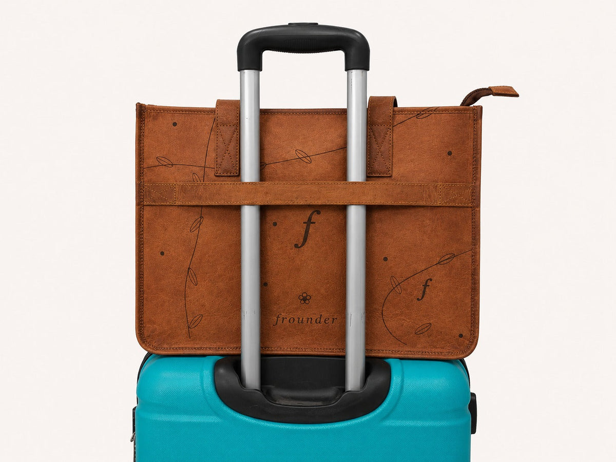 Meadow rear luggage band slipped over the handle of a rolling suitcase.