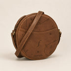 Glade angled view showing the front slip pocket, zip edge and side strap rings.