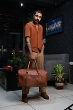 Timberline carried by its twin top handles, showing the bag at the side of the body.