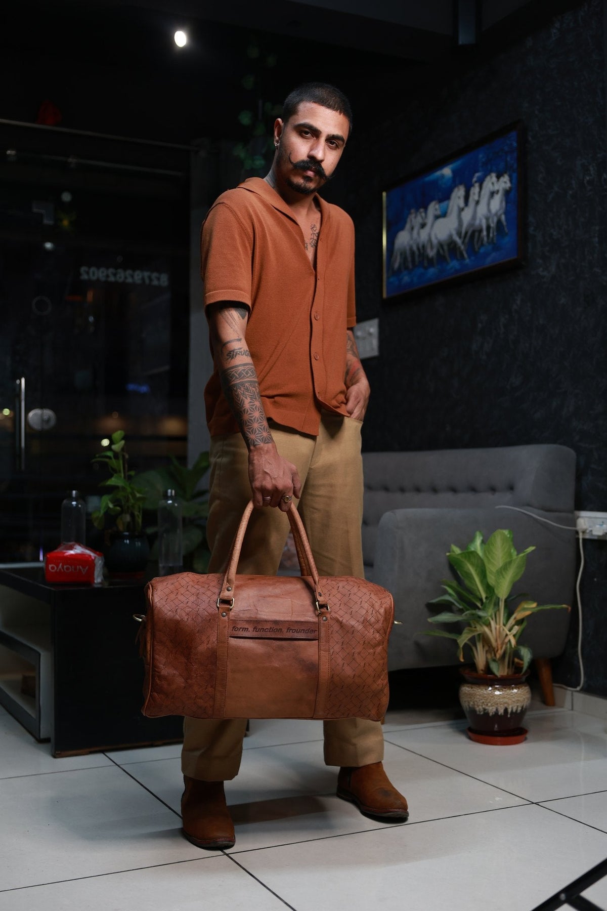 Timberline carried by its twin top handles, showing the bag at the side of the body.