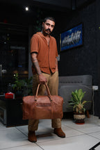 Timberline held by the top handles in a standing lifestyle view.