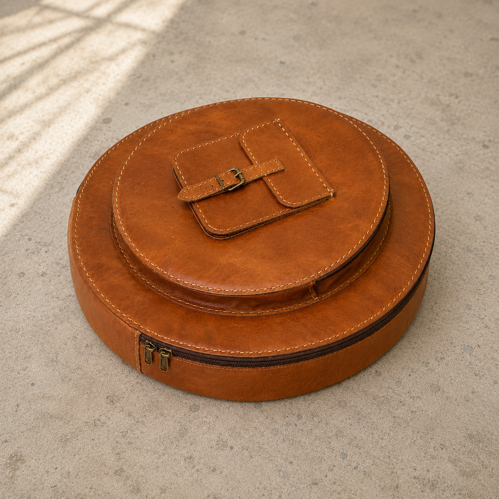 Resonance Cymbal Bag laid flat, showing its circular main compartment, smaller round front compartment and buckled accessory pocket.